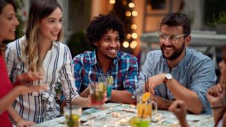 Group of friends having a drink together at party