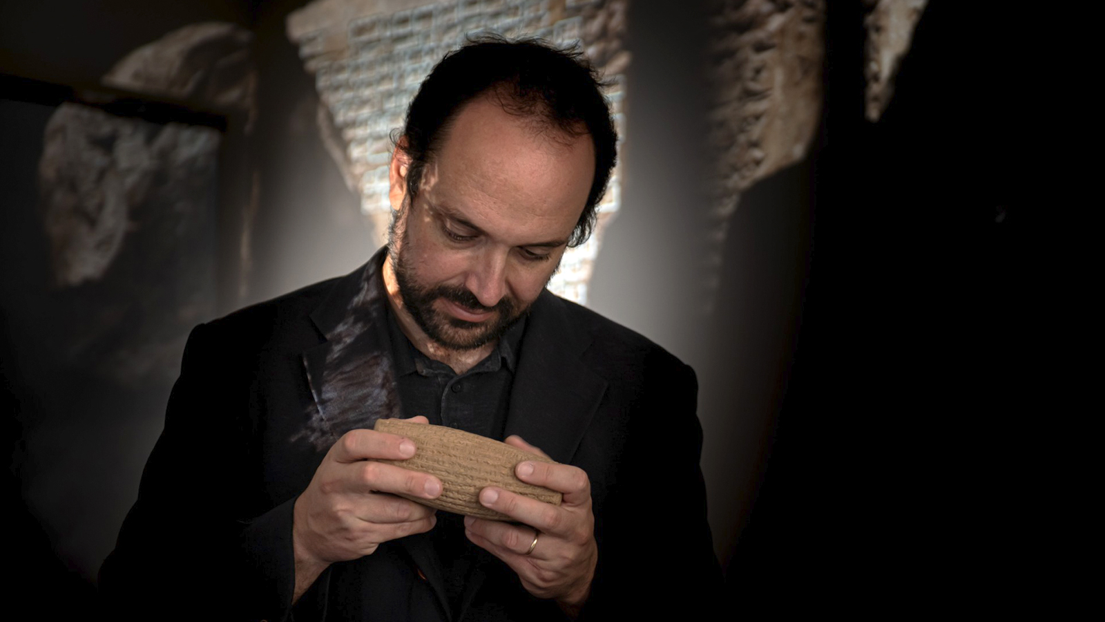 Professor Enrique Jiménez studying a cuneiform tablet