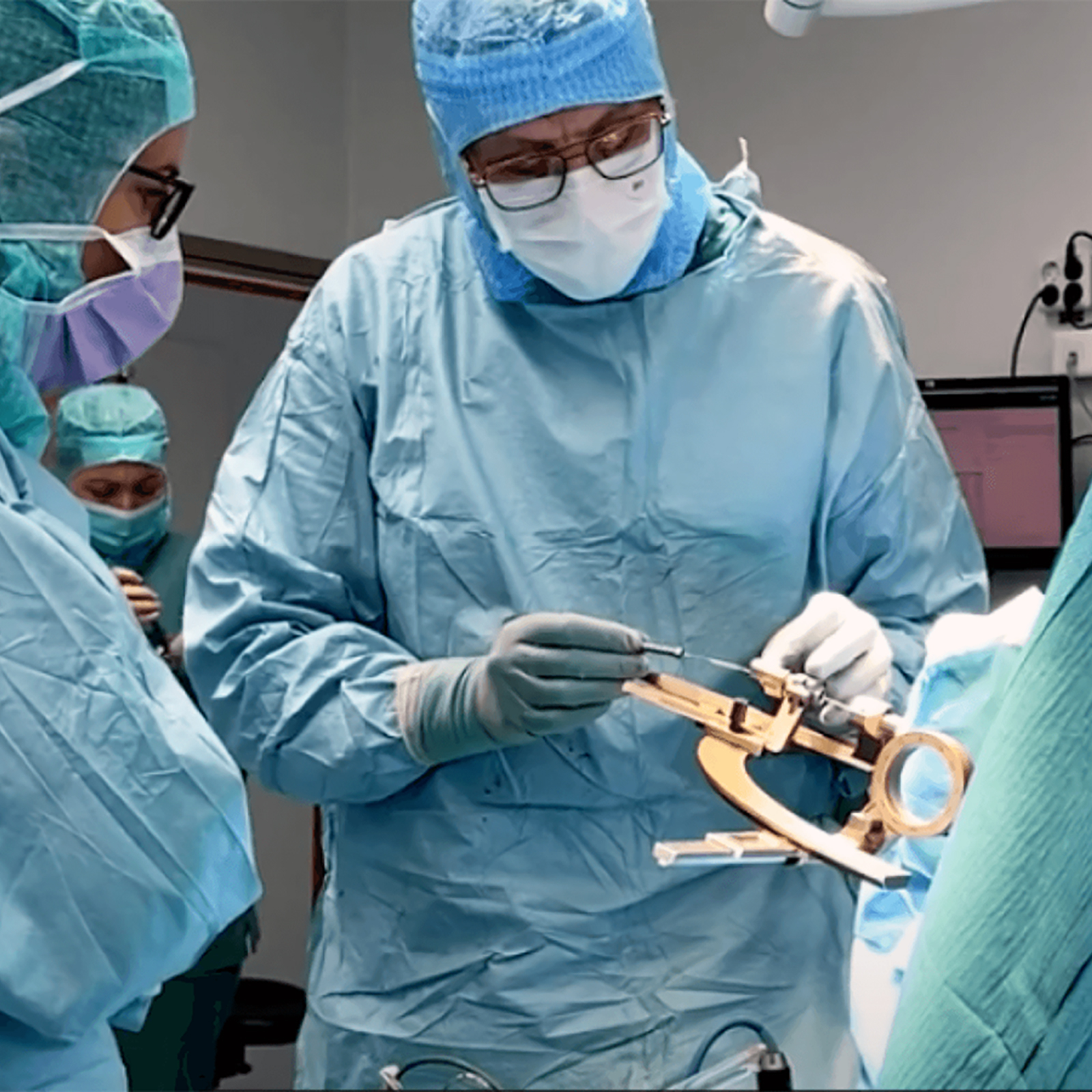 doctors in lab coats performing a procedure on a patient