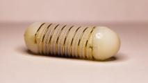 a close up of a pill with a spiral of wire around it